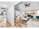 Spacious living room with wood floors, vaulted ceilings, stone fireplace, and open layout leading into kitchen at 12536 116Th St, Largo, FL 33778
