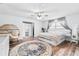 Bright bedroom featuring a ceiling fan, a large window, and ample natural light highlighting the serene space at 12536 116Th St, Largo, FL 33778