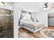Bright bedroom featuring a ceiling fan, a large window, and ample natural light highlighting the serene space at 12536 116Th St, Largo, FL 33778