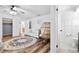 Bright bedroom featuring a ceiling fan, a large window, and ample natural light highlighting the serene space at 12536 116Th St, Largo, FL 33778
