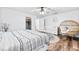 Bright bedroom featuring a ceiling fan, a large window, and ample natural light highlighting the serene space at 12536 116Th St, Largo, FL 33778