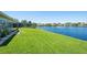 Beautiful backyard featuring a lush green lawn extending to a serene lake at 13797 Pinecrest Dr, Largo, FL 33774