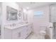Bright bathroom features dual sinks, large mirror, and marble floors at 13797 Pinecrest Dr, Largo, FL 33774