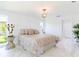 Bright bedroom with chandelier, modern decor and ensuite bath at 13797 Pinecrest Dr, Largo, FL 33774