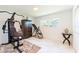 Well-lit exercise room featuring exercise machines, armoire and marble floors at 13797 Pinecrest Dr, Largo, FL 33774