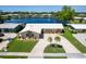 Beautiful waterfront home with manicured lawn, circular driveway, and lush landscaping offering picturesque views at 13797 Pinecrest Dr, Largo, FL 33774