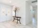Bright foyer features double doors, marble floors, a console table, and fresh white paint at 13797 Pinecrest Dr, Largo, FL 33774