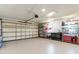 Spacious garage with epoxy flooring, overhead door, and storage shelves at 13797 Pinecrest Dr, Largo, FL 33774