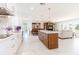 Bright open-concept kitchen with dining and living areas, featuring a large island and stainless steel appliances at 13797 Pinecrest Dr, Largo, FL 33774
