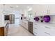 Bright white kitchen with stainless steel appliances and marble floors at 13797 Pinecrest Dr, Largo, FL 33774
