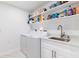 Well lit laundry room with shelving for storage at 13797 Pinecrest Dr, Largo, FL 33774