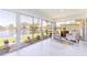 Sunroom features large windows, lake view and seating area at 13797 Pinecrest Dr, Largo, FL 33774
