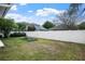 Large backyard features a white privacy fence, garden beds, and ample green space, offering a private and relaxing outdoor area at 1418 Hurley Pond Ln, Valrico, FL 33596