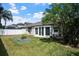 Spacious backyard featuring well-maintained lawn, raised garden beds, and a privacy fence, perfect for outdoor activities at 1418 Hurley Pond Ln, Valrico, FL 33596