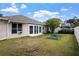 Expansive backyard with well-maintained lawn, garden beds, and patio doors, ideal for relaxation and outdoor entertaining at 1418 Hurley Pond Ln, Valrico, FL 33596
