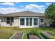 Green backyard features well-kept lawn, garden beds, and a patio, creating a relaxing outdoor living space at 1418 Hurley Pond Ln, Valrico, FL 33596