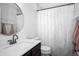 Cozy bathroom featuring a single sink vanity, shower with curtain, and decorative accents, making efficient use of space at 1418 Hurley Pond Ln, Valrico, FL 33596