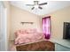 Cozy bedroom with soft pink bedding, plush rug, and a ceiling fan providing a relaxing atmosphere at 1418 Hurley Pond Ln, Valrico, FL 33596