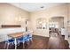 Bright dining area with a chandelier and hardwood floors flowing into the living area at 1418 Hurley Pond Ln, Valrico, FL 33596
