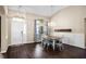 Bright dining room features dark wood floors and a chandelier over the dining table at 1418 Hurley Pond Ln, Valrico, FL 33596