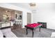 Entertaining game room includes a billiard table, comfortable sofa, and seamless integration with other living spaces at 1418 Hurley Pond Ln, Valrico, FL 33596