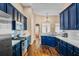 Stylish kitchen showcasing navy cabinets, marble countertops, and modern stainless appliances at 1418 Hurley Pond Ln, Valrico, FL 33596