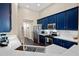 Well-appointed kitchen with navy cabinets, marble countertops, and stainless steel appliances at 1418 Hurley Pond Ln, Valrico, FL 33596