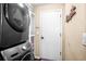 Convenient laundry room with black stacked washer and dryer set, ready for efficient laundry days at 1418 Hurley Pond Ln, Valrico, FL 33596