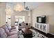Well-lit living room with sofas, a TV, and a view into another room, perfect for entertaining at 1418 Hurley Pond Ln, Valrico, FL 33596