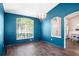 Bright living room with a large window, chandelier, and seamless flow into the adjacent room at 1418 Hurley Pond Ln, Valrico, FL 33596
