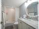 Bathroom with tub, shower, granite counters, and decorative mirror at 15462 Gulf Blvd # 904, Madeira Beach, FL 33708