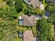 Aerial view of a private home with a screened-in pool, surrounded by lush greenery and mature trees at 15930 Sorawater Dr, Lithia, FL 33547
