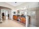 Bathroom with dual vanities, walk-in shower, and bathtub adjacent to the bedroom at 15930 Sorawater Dr, Lithia, FL 33547
