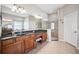 Large bathroom with dual vanities, a glass shower, a garden tub, tile floors and natural light at 15930 Sorawater Dr, Lithia, FL 33547