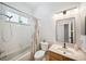 A bright bathroom with a shower-tub combo, updated vanity, a window, and a neutral color scheme at 15930 Sorawater Dr, Lithia, FL 33547