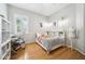 Bright bedroom featuring a workspace, wood floors, and a stylish colorful bed at 15930 Sorawater Dr, Lithia, FL 33547