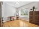 Bright room featuring a window with shutters, bamboo floors, and a sewing table with easel at 15930 Sorawater Dr, Lithia, FL 33547