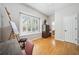 Bright room featuring a window with shutters, bamboo floors, sewing desk, and armoire at 15930 Sorawater Dr, Lithia, FL 33547