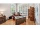 Bright bedroom seating area with hardwood floors and natural light from large windows at 15930 Sorawater Dr, Lithia, FL 33547