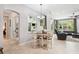 Cozy dining area with a round table, four chairs, and views of the backyard, ideal for Gathering meals at 15930 Sorawater Dr, Lithia, FL 33547