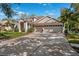Beautiful home features a three-car garage, well-manicured lawn, and a basketball hoop on the driveway at 15930 Sorawater Dr, Lithia, FL 33547