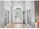 Bright foyer with tiled floors, high ceilings, decorative chandelier, and double doors to other rooms at 15930 Sorawater Dr, Lithia, FL 33547