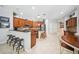 Spacious kitchen featuring wooden cabinets, granite counters, stainless steel appliances, and a convenient breakfast bar at 15930 Sorawater Dr, Lithia, FL 33547