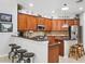 Kitchen with cherry cabinets, breakfast bar, granite counters, stainless steel appliances, and custom lighting at 15930 Sorawater Dr, Lithia, FL 33547