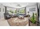 Spacious living room featuring a large sofa, area rug, and sliding glass doors leading to the outdoor area at 15930 Sorawater Dr, Lithia, FL 33547