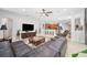 Spacious living room featuring an open floor plan, large TV, and a ceiling fan at 15930 Sorawater Dr, Lithia, FL 33547