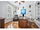 Comfortable office with hardwood floors, large window, built in shelves and a leather reclining chair at 15930 Sorawater Dr, Lithia, FL 33547