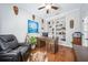 Bright home office with hardwood flooring, dark leather recliner, and beautiful decorative masks at 15930 Sorawater Dr, Lithia, FL 33547