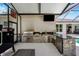 Amazing outdoor kitchen with stainless steel appliances, granite countertop bar, and space for entertaining at 15930 Sorawater Dr, Lithia, FL 33547
