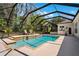 A fenced in pool with built in hot tub, with an outdoor kitchen, patio and lounge chairs at 15930 Sorawater Dr, Lithia, FL 33547